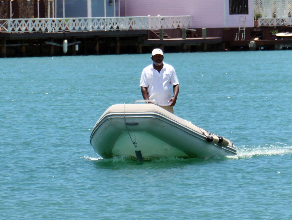 A member of the dock team on the dinghy